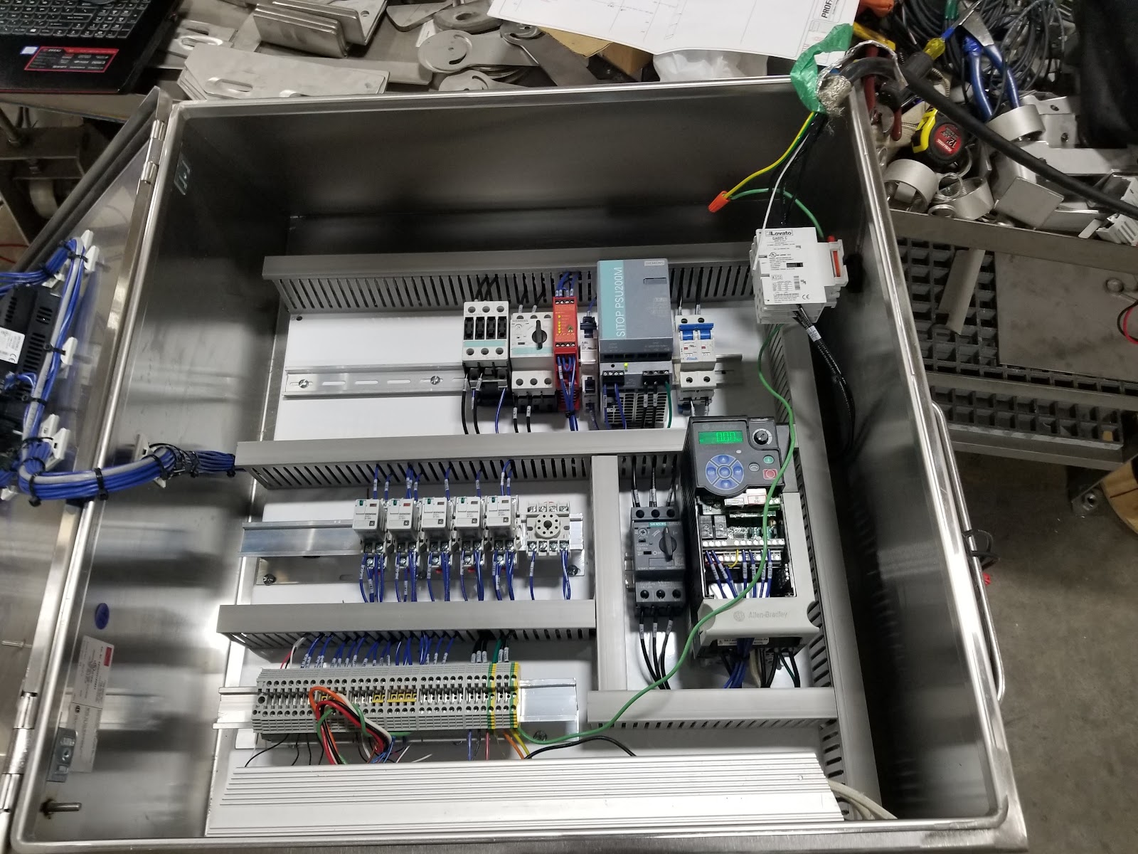 Stainless control box interior with breakers, terminals, and clean wiring.
