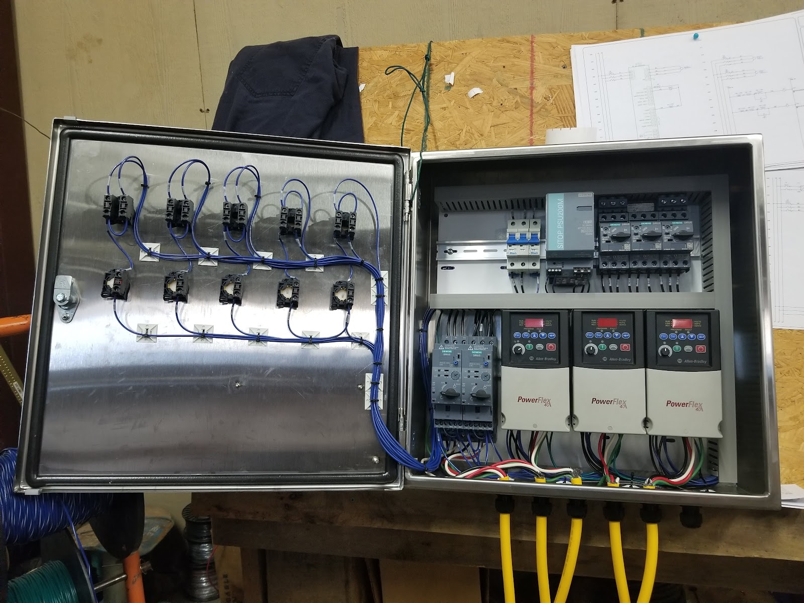 Open stainless enclosure on the shop bench with drives and operator buttons.