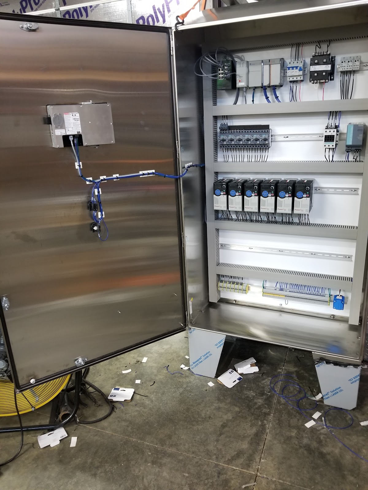 Open stainless cabinet with organized wiring and terminal blocks.