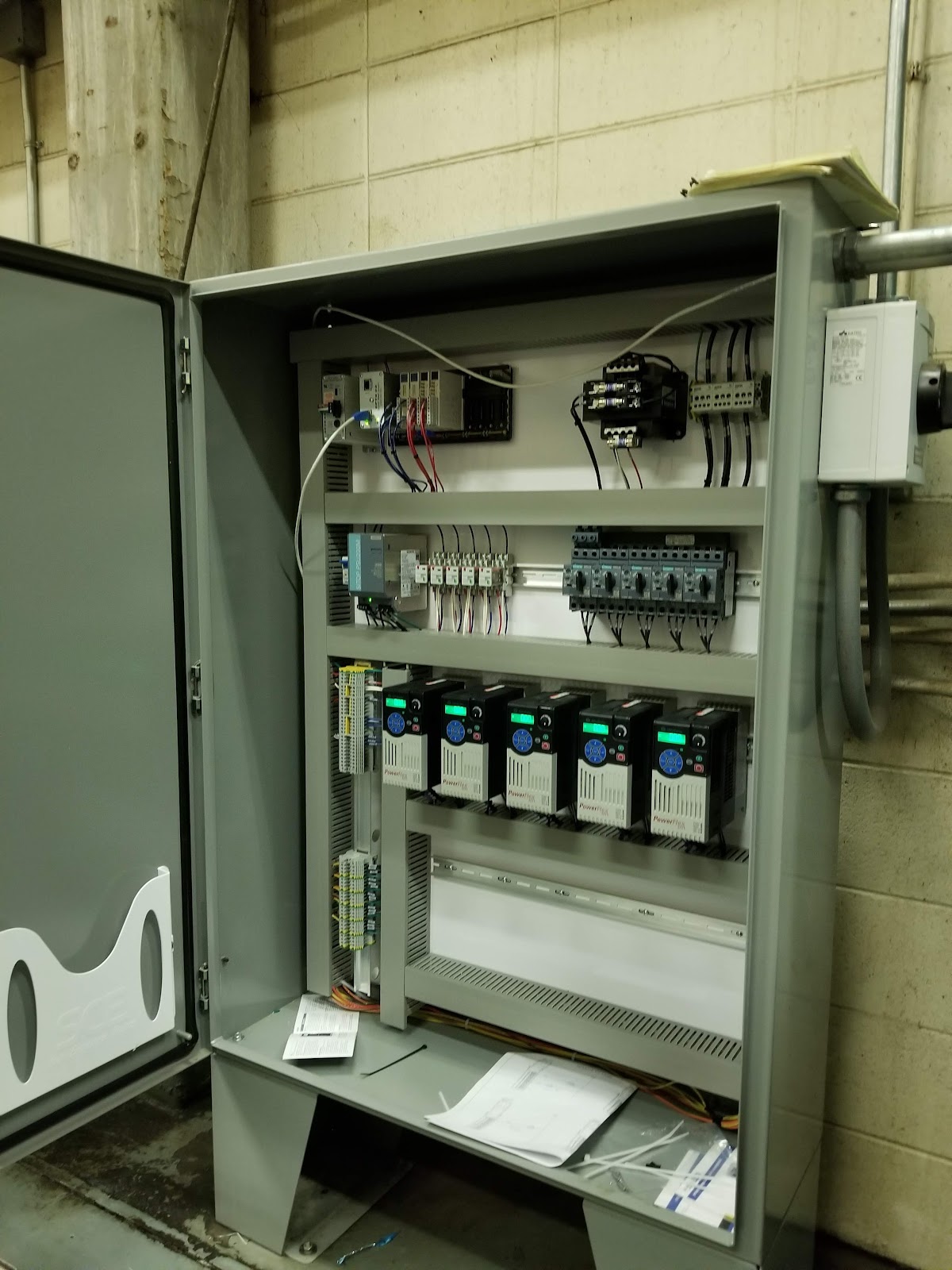 Floor-standing open cabinet with rows of power components.