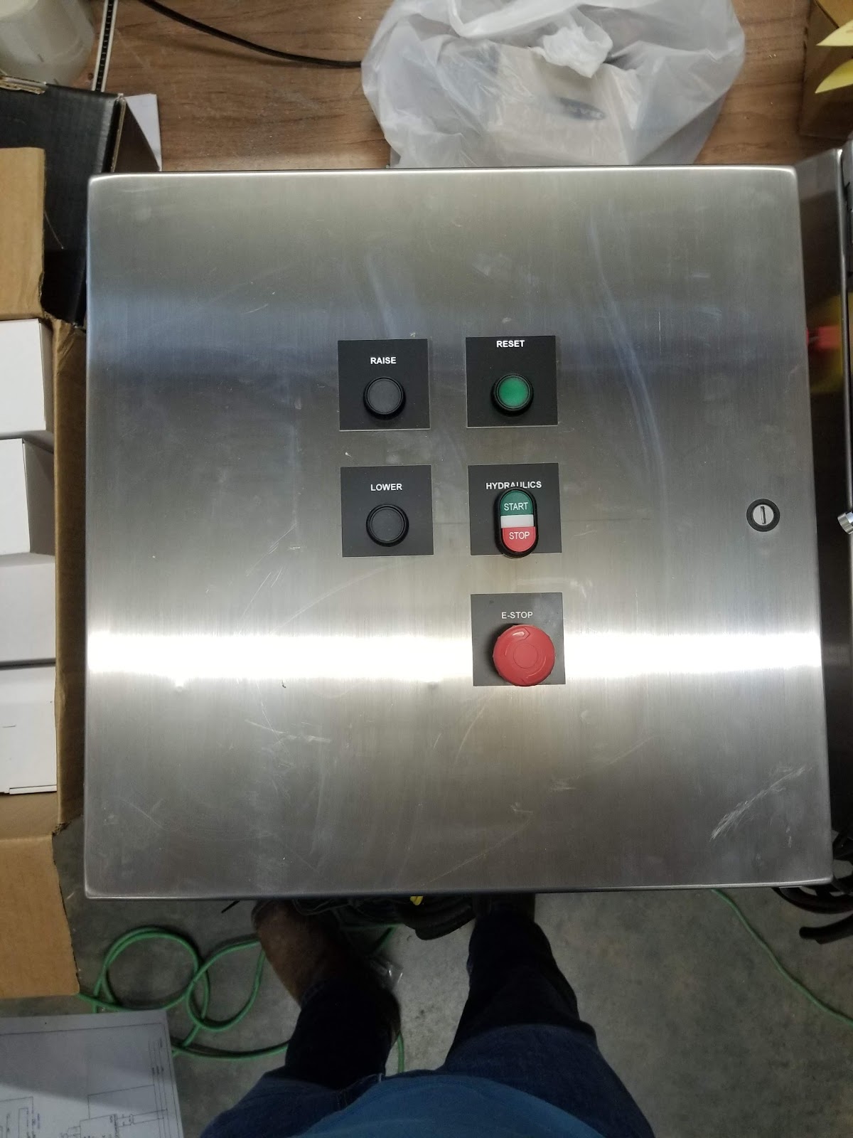 Stainless control box face with selector switches and emergency stop.