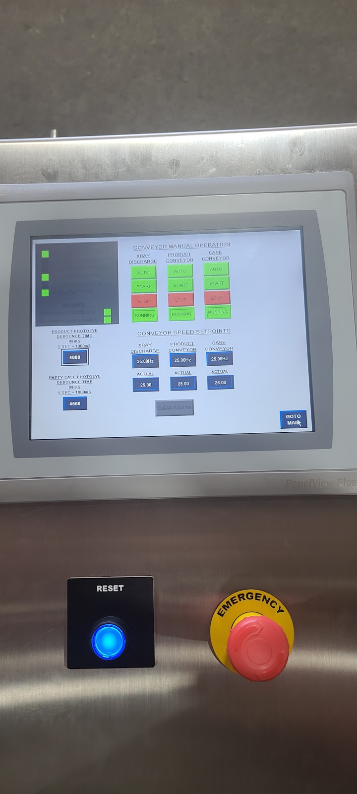 Panel face with a small HMI, illuminated button, and emergency stop.
