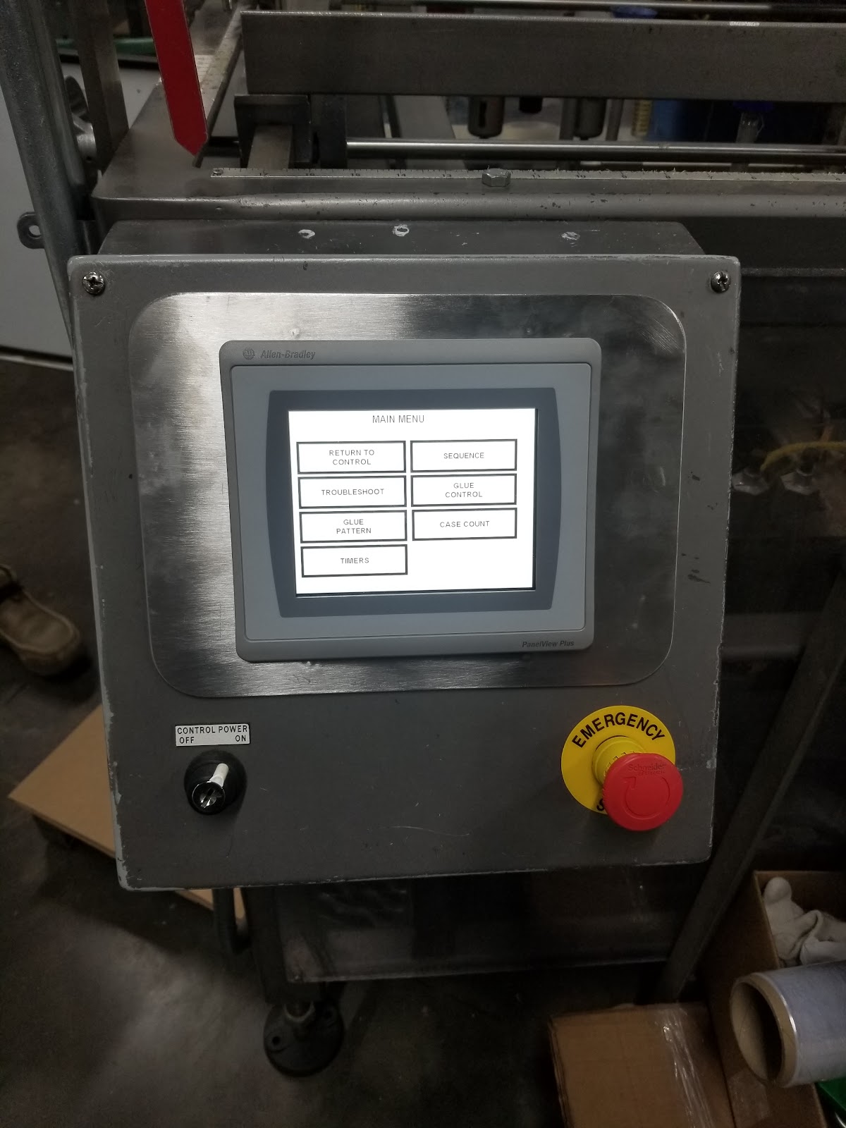 Stainless door with a small HMI and red emergency stop.