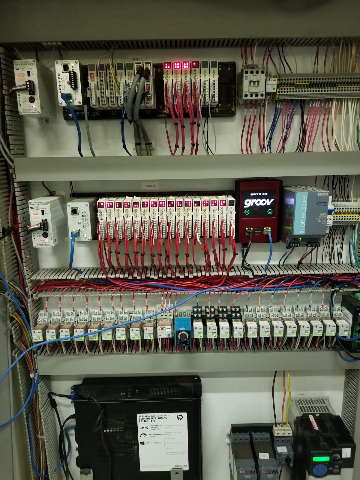 Cabinet interior with I/O racks, power supplies, relays, and drives.