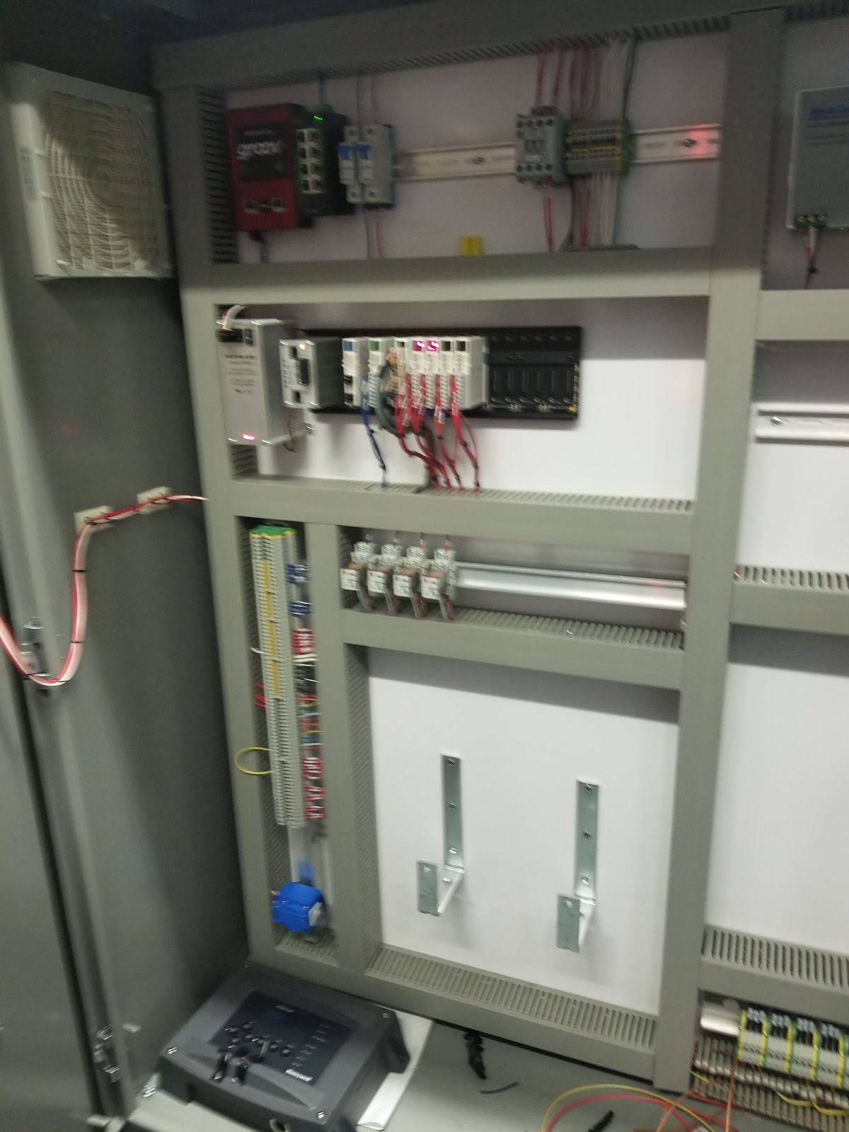Partially populated cabinet with mounting rails and wire duct.