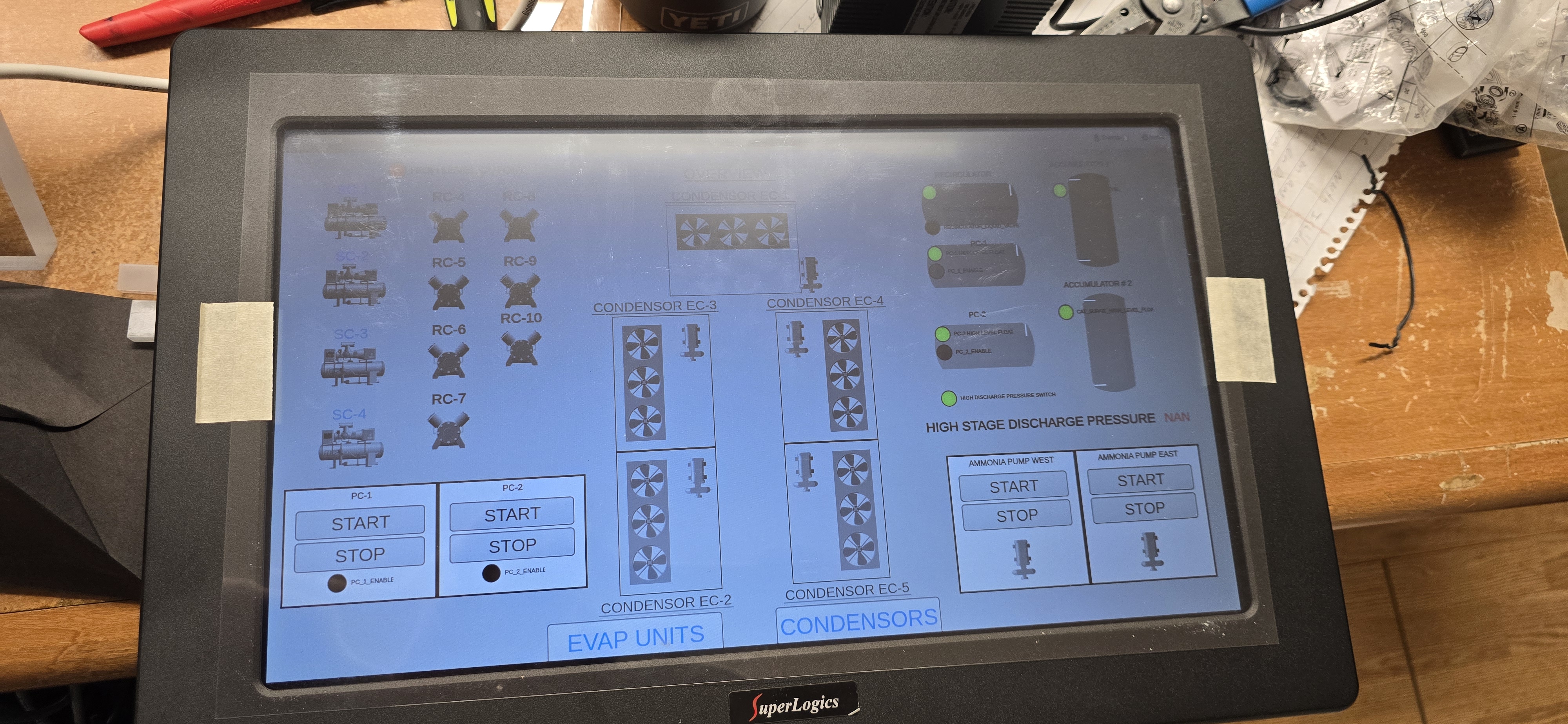 Industrial HMI on the bench showing compressors, condensers, and pumps.